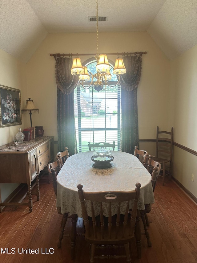 5875 White Ridge Cir W, Olive Branch, MS 38654 - dining area featuring vaulted ceiling, dark wood finished floors, a chandelier, and a textured ceiling