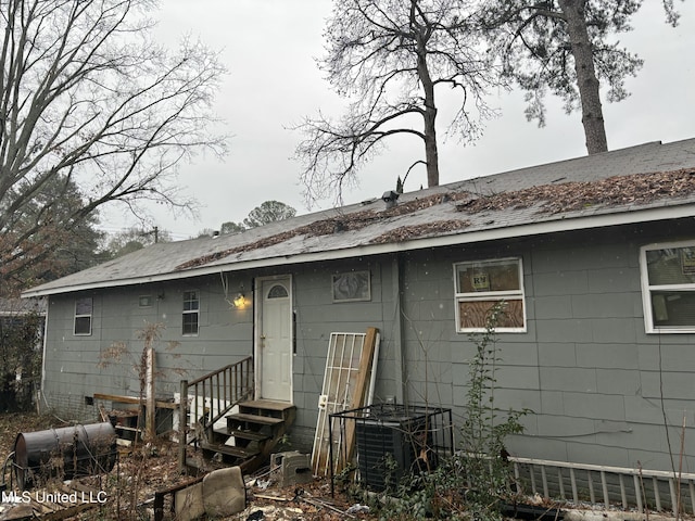 rear view of house featuring central air condition unit and entry steps