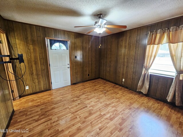 800 S Main St, Picayune, MS 39466 - entrance foyer featuring light wood-style floors, wooden walls, ceiling fan, and a textured ceiling