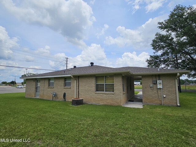 800 S Main St, Picayune, MS 39466 - back of property with a lawn, brick siding, and roof with shingles
