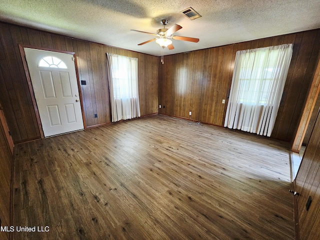 800 S Main St, Picayune, MS 39466 - entrance foyer with wood finished floors, a ceiling fan, wood walls, and a textured ceiling