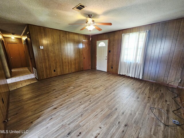 800 S Main St, Picayune, MS 39466 - entryway featuring wood finished floors, a ceiling fan, wooden walls, and a textured ceiling