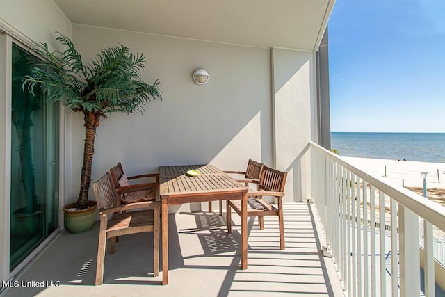 balcony featuring a water view and a view of the beach