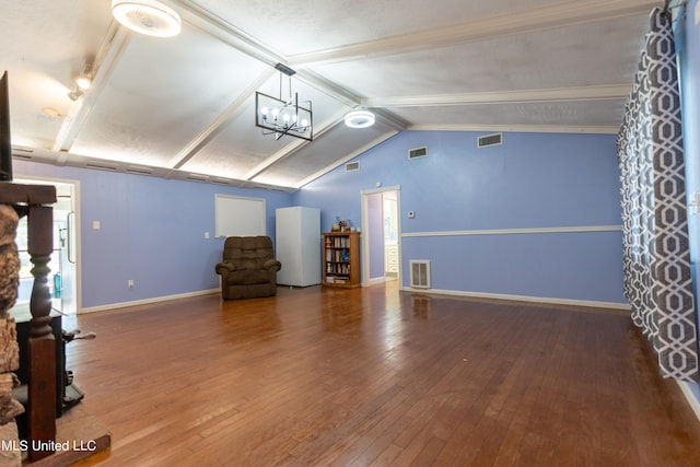 interior space featuring hardwood / wood-style flooring, lofted ceiling with beams, a healthy amount of sunlight, and an inviting chandelier