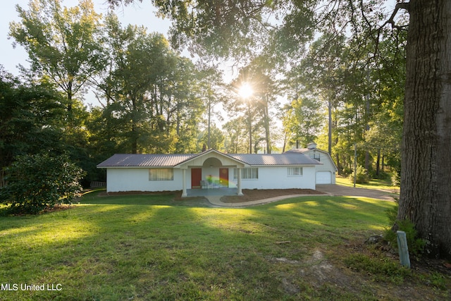 ranch-style home featuring a garage and a front lawn