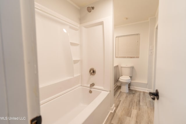 full bathroom featuring shower / bath combination, toilet, hardwood / wood-style flooring, vanity, and ornamental molding