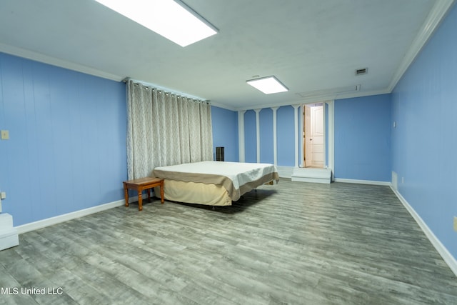 bedroom featuring crown molding and wood-type flooring