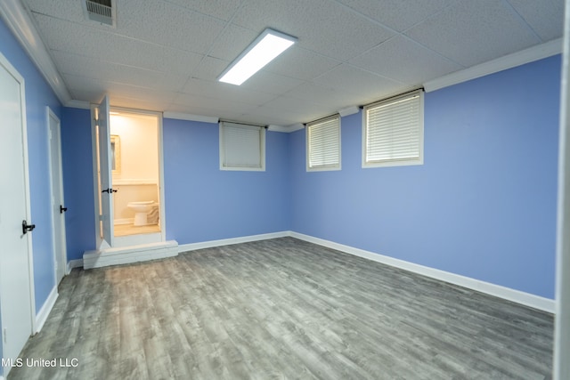 basement with hardwood / wood-style flooring and ornamental molding