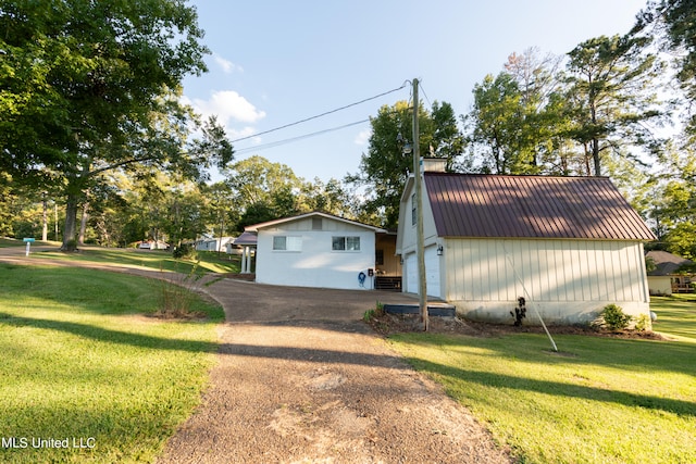 view of home's exterior with a lawn, an outbuilding, and a garage