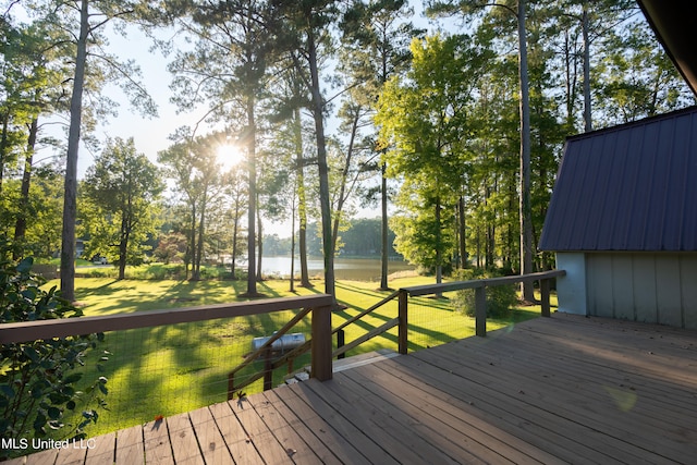 wooden deck featuring a lawn