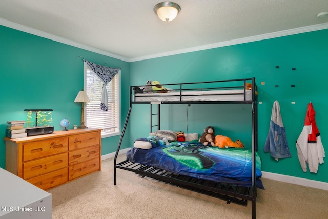 carpeted bedroom featuring baseboards, ornamental molding, and a textured ceiling