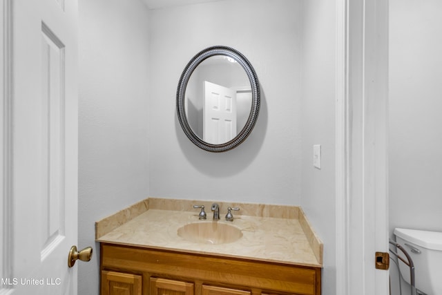 half bath featuring toilet and vanity