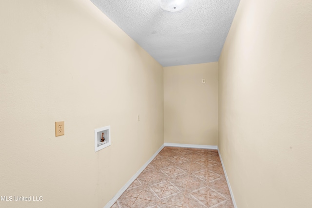 laundry room with light tile patterned floors, laundry area, hookup for a washing machine, baseboards, and a textured ceiling