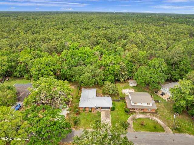 birds eye view of property featuring a wooded view