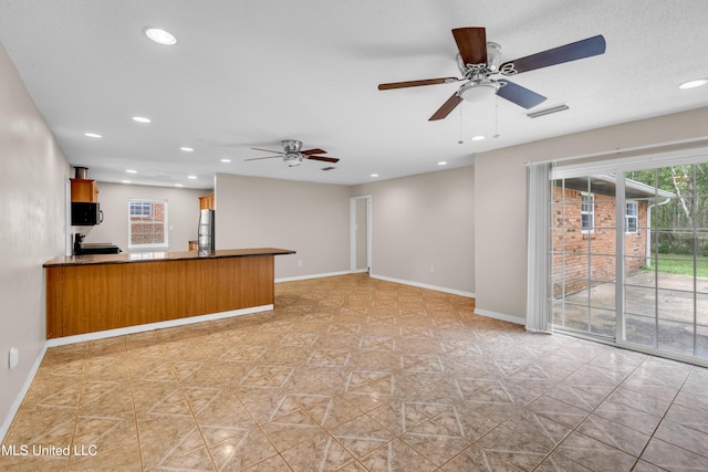 unfurnished living room featuring baseboards, recessed lighting, visible vents, and ceiling fan
