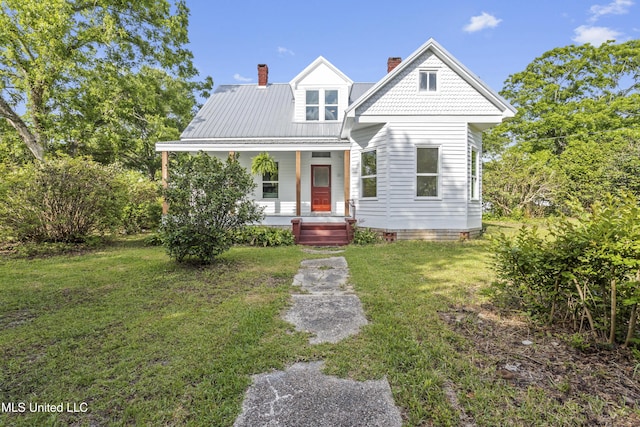 21021 Old River Rd, Vancleave, MS 39565 - view of front of house featuring covered porch, a chimney, a front yard, and metal roof