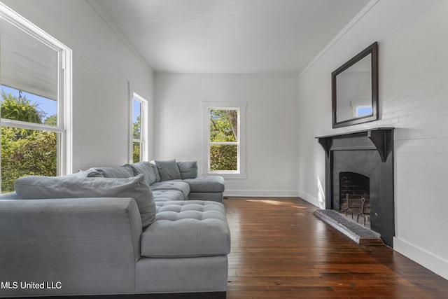 21021 Old River Rd, Vancleave, MS 39565 - living area featuring crown molding, wood-type flooring, baseboards, and a fireplace with raised hearth