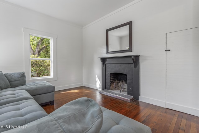 21021 Old River Rd, Vancleave, MS 39565 - living room featuring crown molding, hardwood / wood-style floors, a fireplace with raised hearth, and baseboards