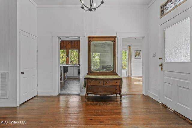 21021 Old River Rd, Vancleave, MS 39565 - entrance foyer featuring wood-type flooring, a high ceiling, ornamental molding, a chandelier, and baseboards