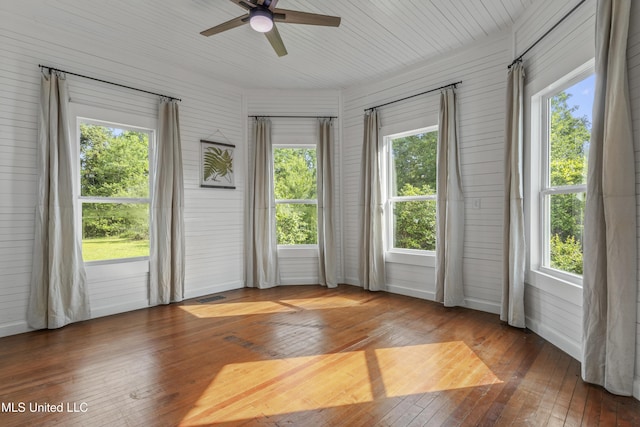 21021 Old River Rd, Vancleave, MS 39565 - unfurnished room featuring wood-type flooring, ceiling fan, and wood walls