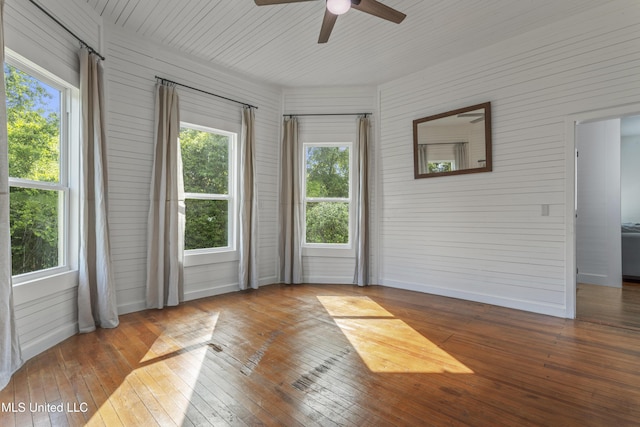 21021 Old River Rd, Vancleave, MS 39565 - empty room featuring hardwood / wood-style floors, ceiling fan, wood walls, and baseboards