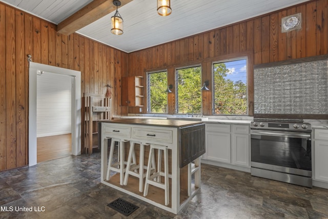21021 Old River Rd, Vancleave, MS 39565 - kitchen with stainless steel electric range oven, wooden walls, wooden ceiling, beamed ceiling, and white cabinets