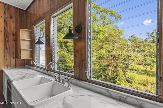 21021 Old River Rd, Vancleave, MS 39565 - kitchen featuring wooden walls, a sink, plenty of natural light, and marble tiled floors