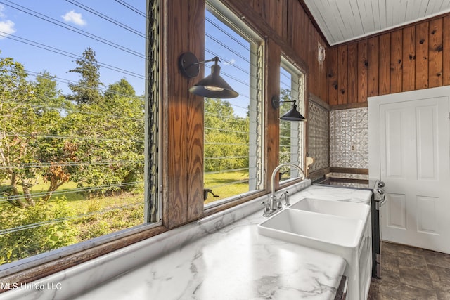 21021 Old River Rd, Vancleave, MS 39565 - kitchen featuring wooden walls, plenty of natural light, stainless steel electric range oven, light countertops, and a sink