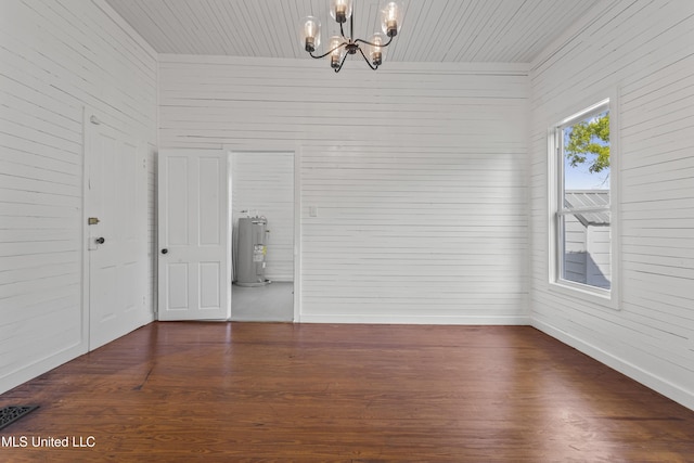 21021 Old River Rd, Vancleave, MS 39565 - spare room featuring electric water heater, a chandelier, dark wood-type flooring, baseboards, and wooden ceiling