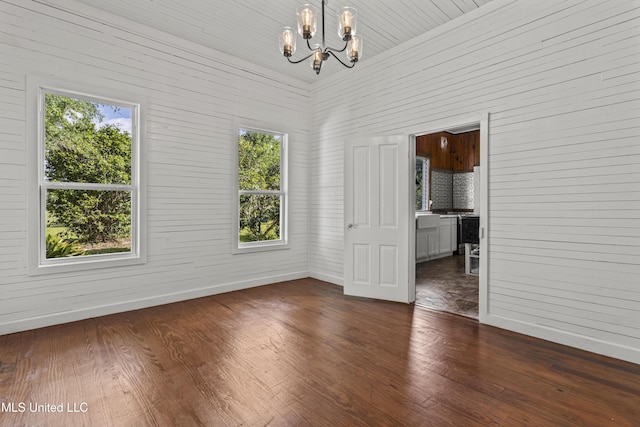 21021 Old River Rd, Vancleave, MS 39565 - unfurnished room featuring a chandelier, baseboards, and dark wood-type flooring