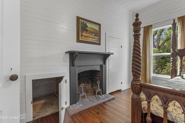 21021 Old River Rd, Vancleave, MS 39565 - detailed view of wood walls, a fireplace with raised hearth, and wood finished floors