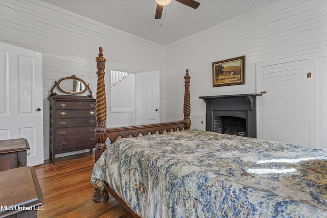 21021 Old River Rd, Vancleave, MS 39565 - bedroom featuring wood finished floors, ceiling fan, and a fireplace