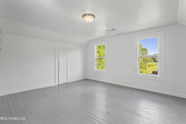 21021 Old River Rd, Vancleave, MS 39565 - empty room featuring vaulted ceiling, healthy amount of natural light, wood-type flooring, and baseboards