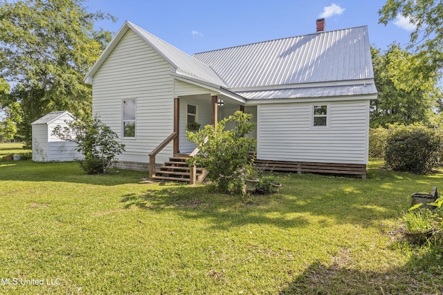 21021 Old River Rd, Vancleave, MS 39565 - back of house with a lawn, metal roof, and a chimney