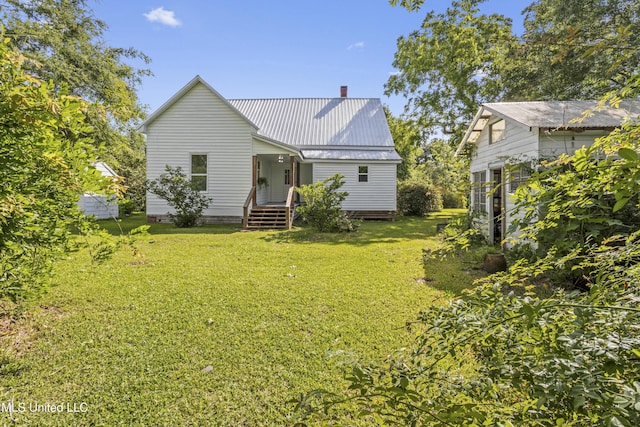 21021 Old River Rd, Vancleave, MS 39565 - back of property featuring a yard, a chimney, and metal roof