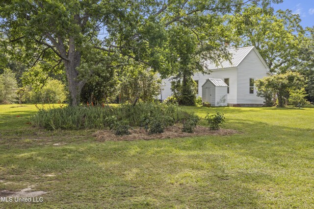 21021 Old River Rd, Vancleave, MS 39565 - view of grassy yard with a storage shed and an outdoor structure