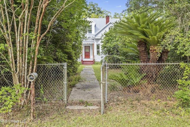 21021 Old River Rd, Vancleave, MS 39565 - view of front of property featuring a gate, a fenced front yard, a chimney, and metal roof