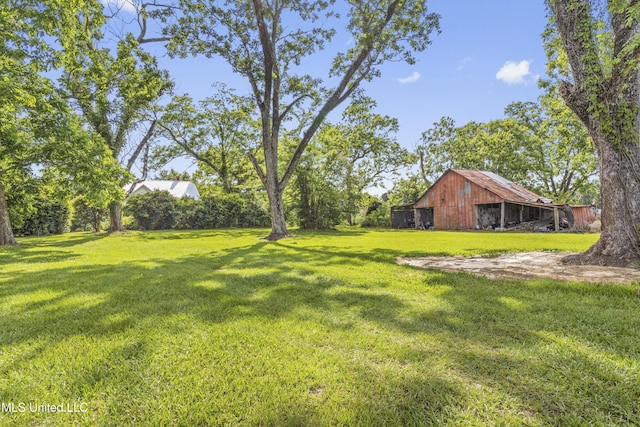 21021 Old River Rd, Vancleave, MS 39565 - view of green lawn with a barn and an outdoor structure
