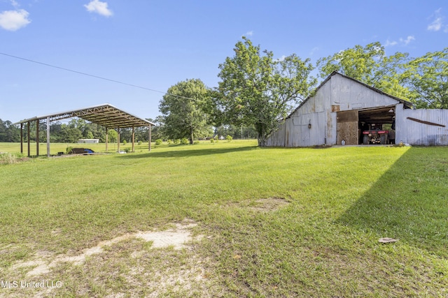 21021 Old River Rd, Vancleave, MS 39565 - view of grassy yard featuring an outbuilding and a detached carport