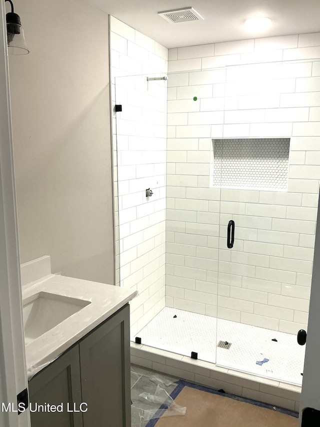 full bathroom with a shower stall, visible vents, and vanity