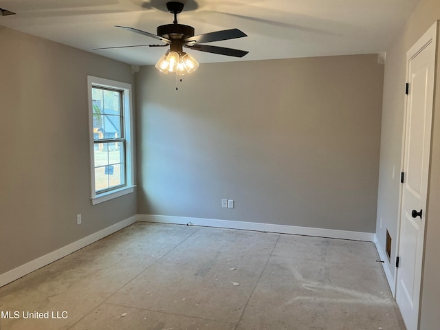 unfurnished room with ceiling fan and baseboards