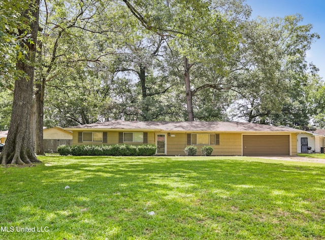 ranch-style home featuring a front lawn and a garage