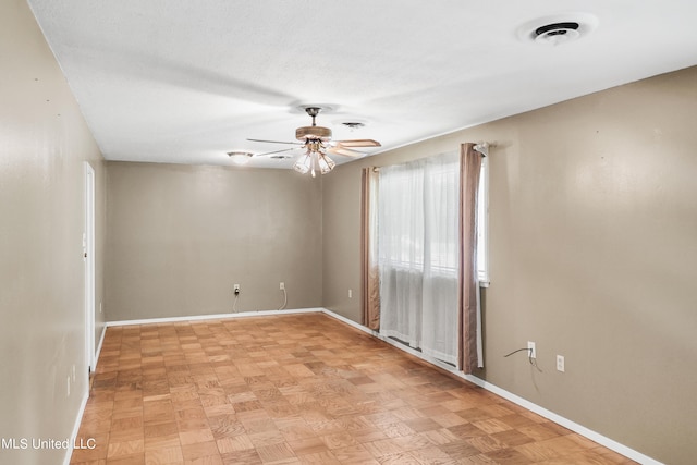 spare room with light parquet floors and ceiling fan