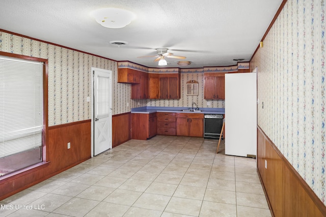 kitchen featuring black dishwasher, sink, white fridge, a textured ceiling, and ceiling fan