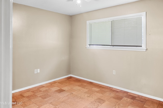 unfurnished room with light parquet floors and ceiling fan