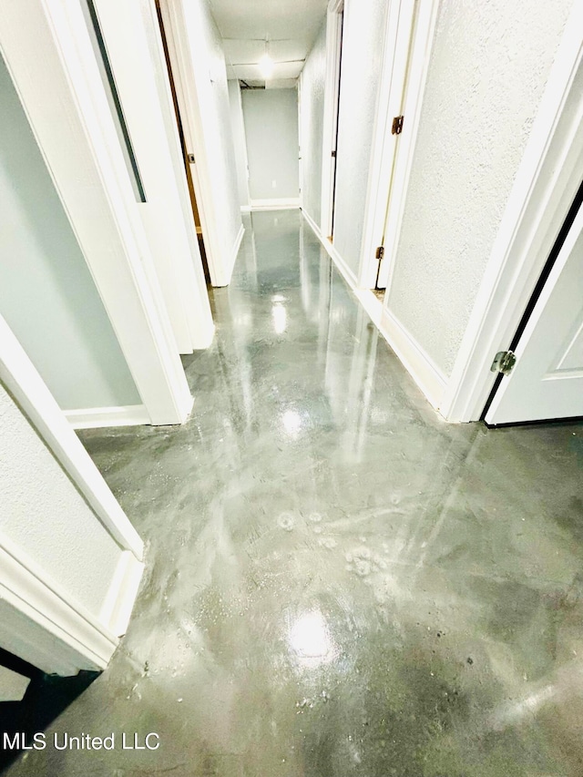 hallway featuring concrete flooring