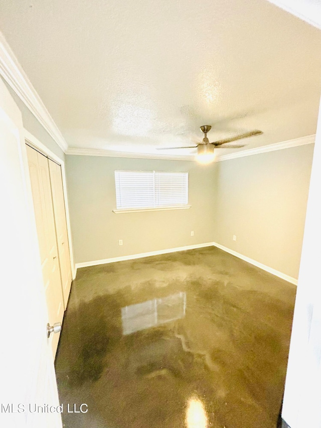 unfurnished bedroom featuring ornamental molding, a textured ceiling, carpet flooring, and ceiling fan