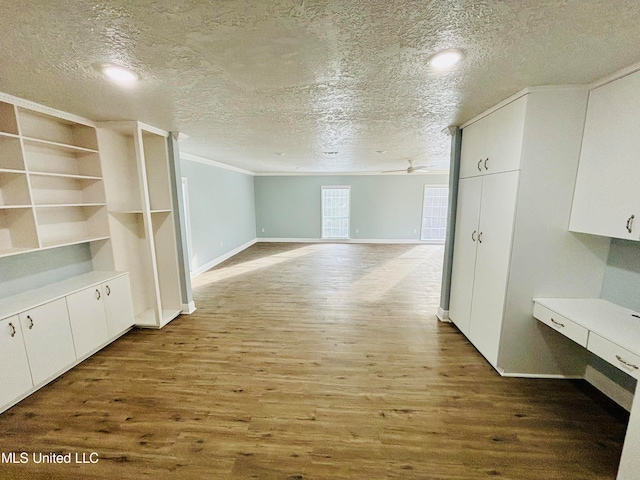 bonus room featuring a textured ceiling and hardwood / wood-style flooring