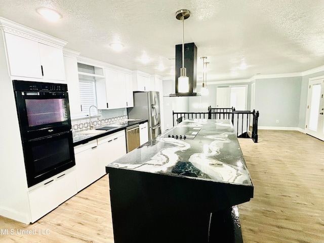 kitchen with a kitchen island, extractor fan, sink, black appliances, and decorative light fixtures