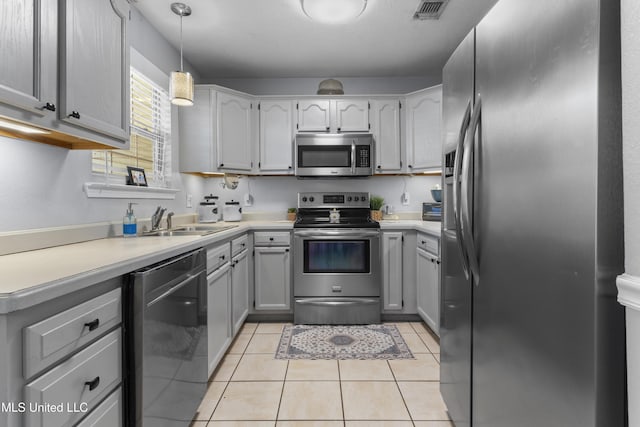 13625 Mount Pleasant Rd, Vancleave, MS 39565 - kitchen with stainless steel appliances, light tile patterned floors, decorative light fixtures, and light countertops